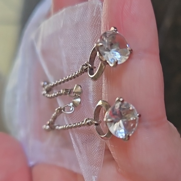 little silver earrings that have a diamond looking ring at the bottom - Picture 2 of 3